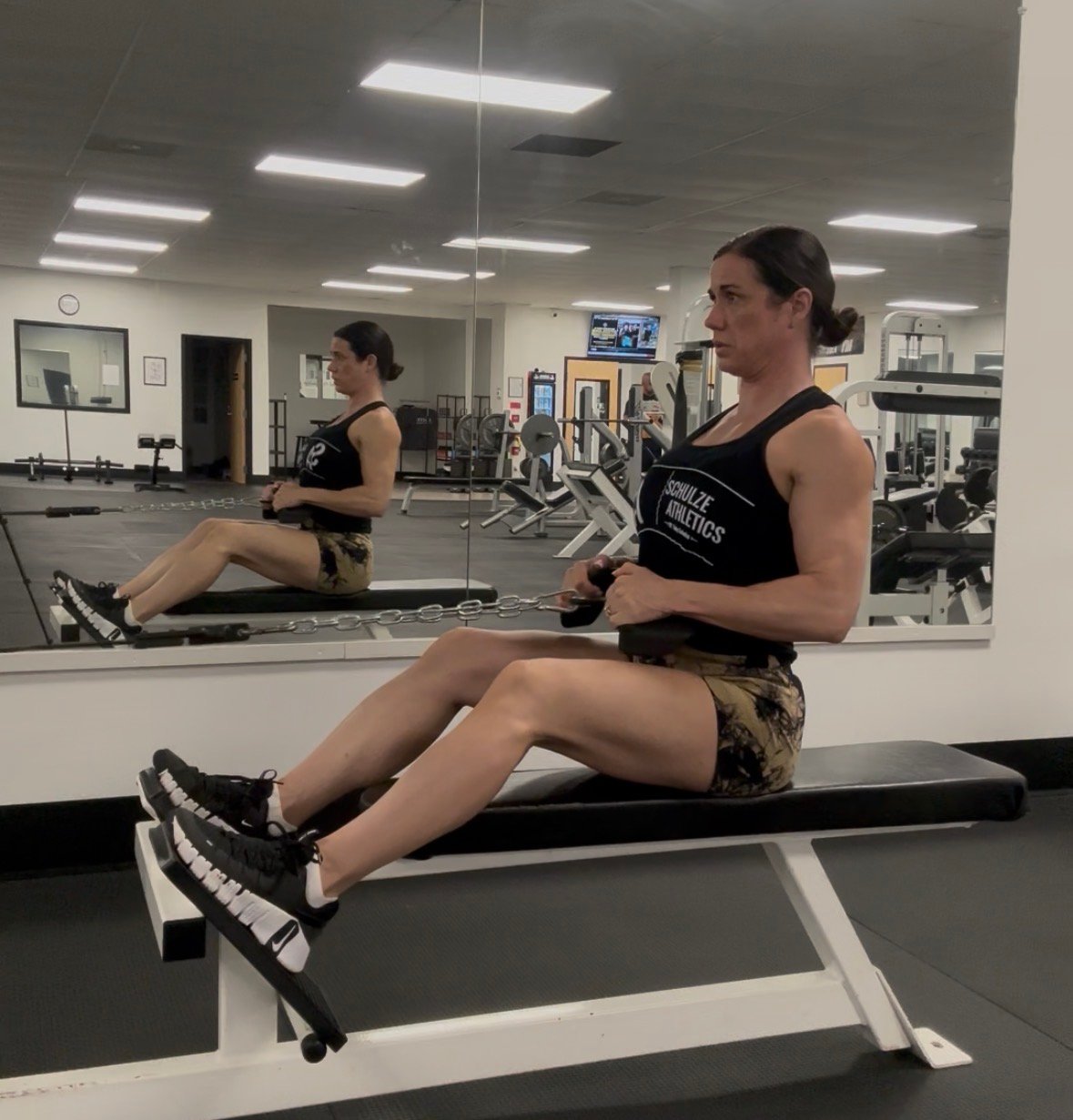 Personal trainer demonstrating cable row variations to improve posture and support everyday movement.